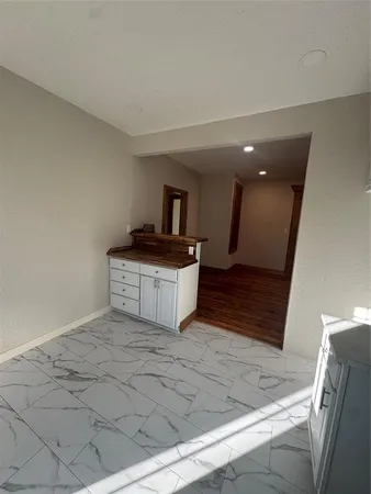 a spacious bathroom with a sink and a mirror