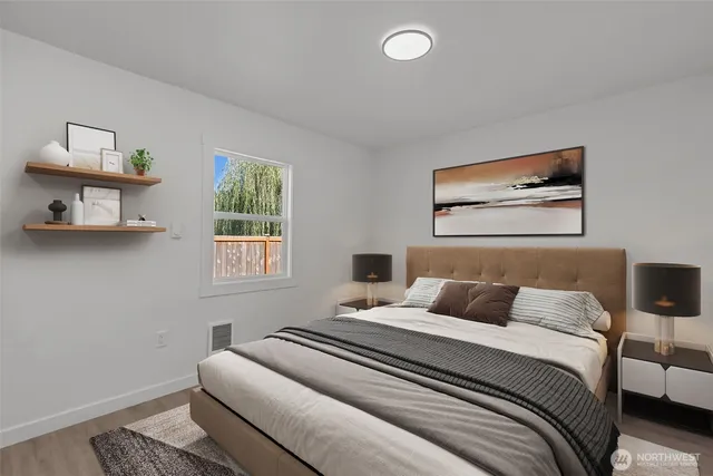 a bedroom with a bed and a painting on the wall