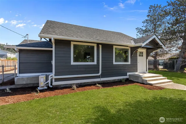 a front view of a house with a garden