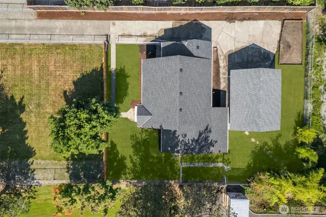 a aerial view of a house with a yard and plants