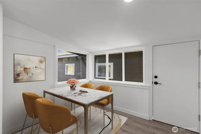 a view of a dining room with furniture window and wooden floor