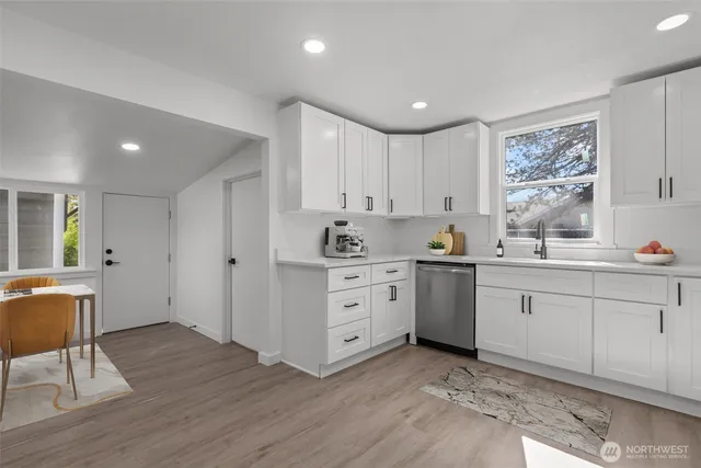a kitchen with white cabinets and white appliances