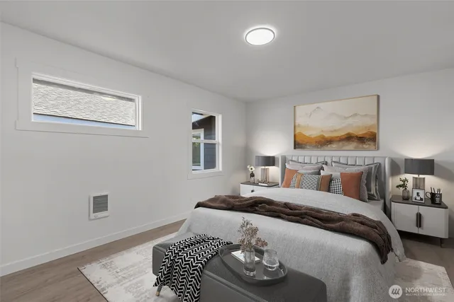 a bedroom with a bed and a painting on the wall