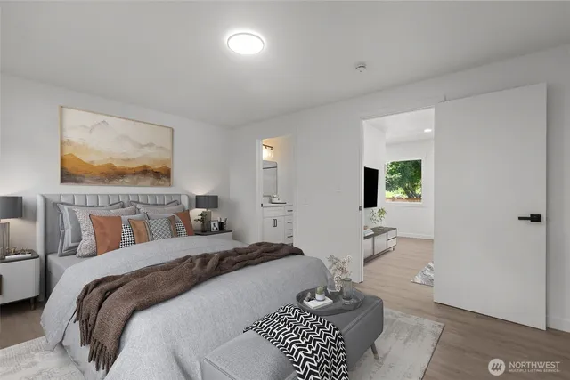 a bedroom with a bed and a painting on the wall