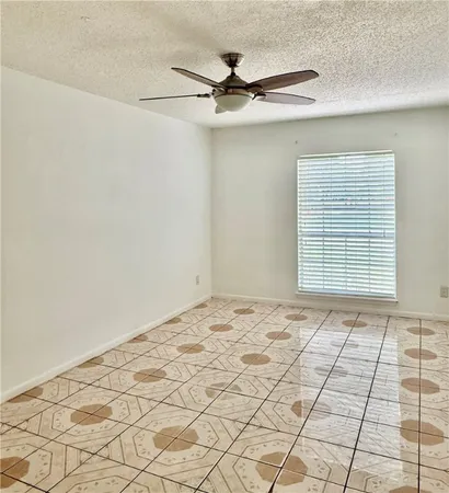 a view of a livingroom with a ceiling fan and window