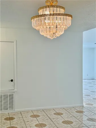 a view of a chandelier fan and wooden floor