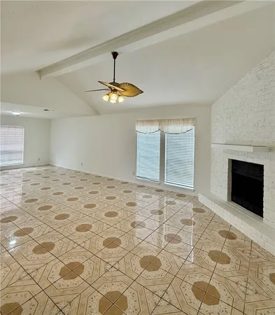 a view of an empty room with a fireplace