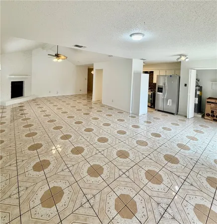 a view of a livingroom with wooden floor and kitchen space
