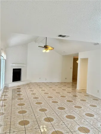 a view of an empty room with a fireplace