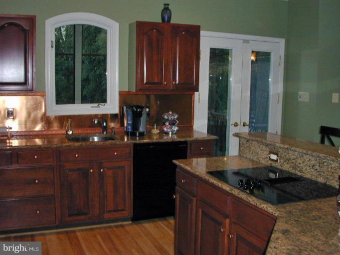 1924 Merrifields Drive Silver Spring, MD 20906 - Photo 7 of 30 Granite, cherry cabinetry, copper backsplash