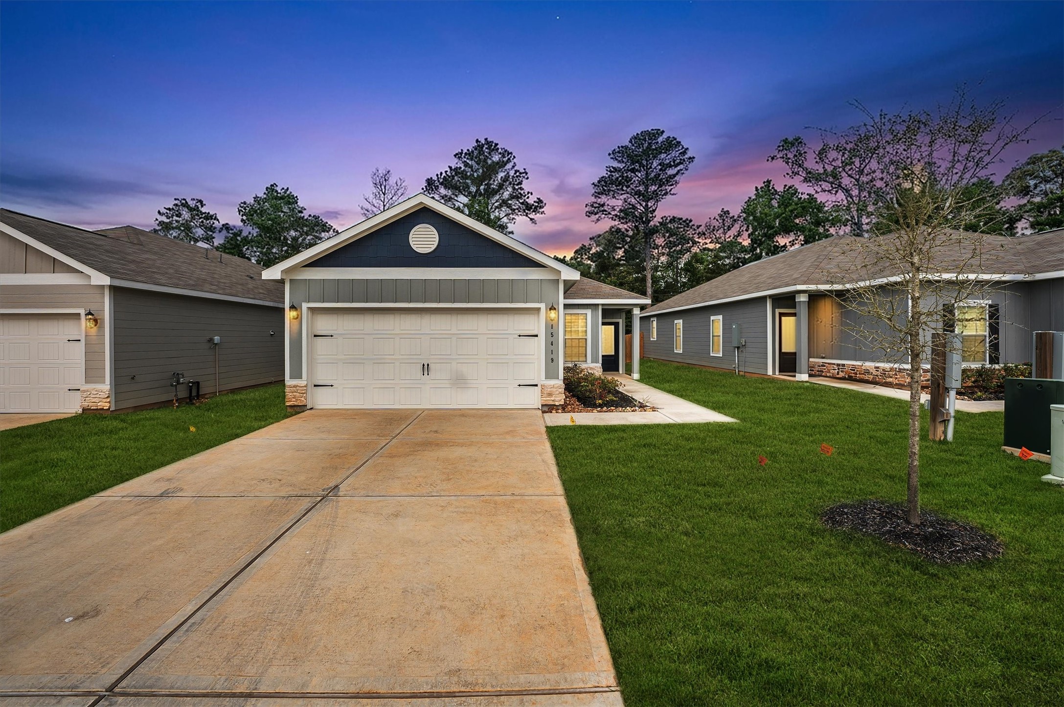 a front view of a house with a yard and garage