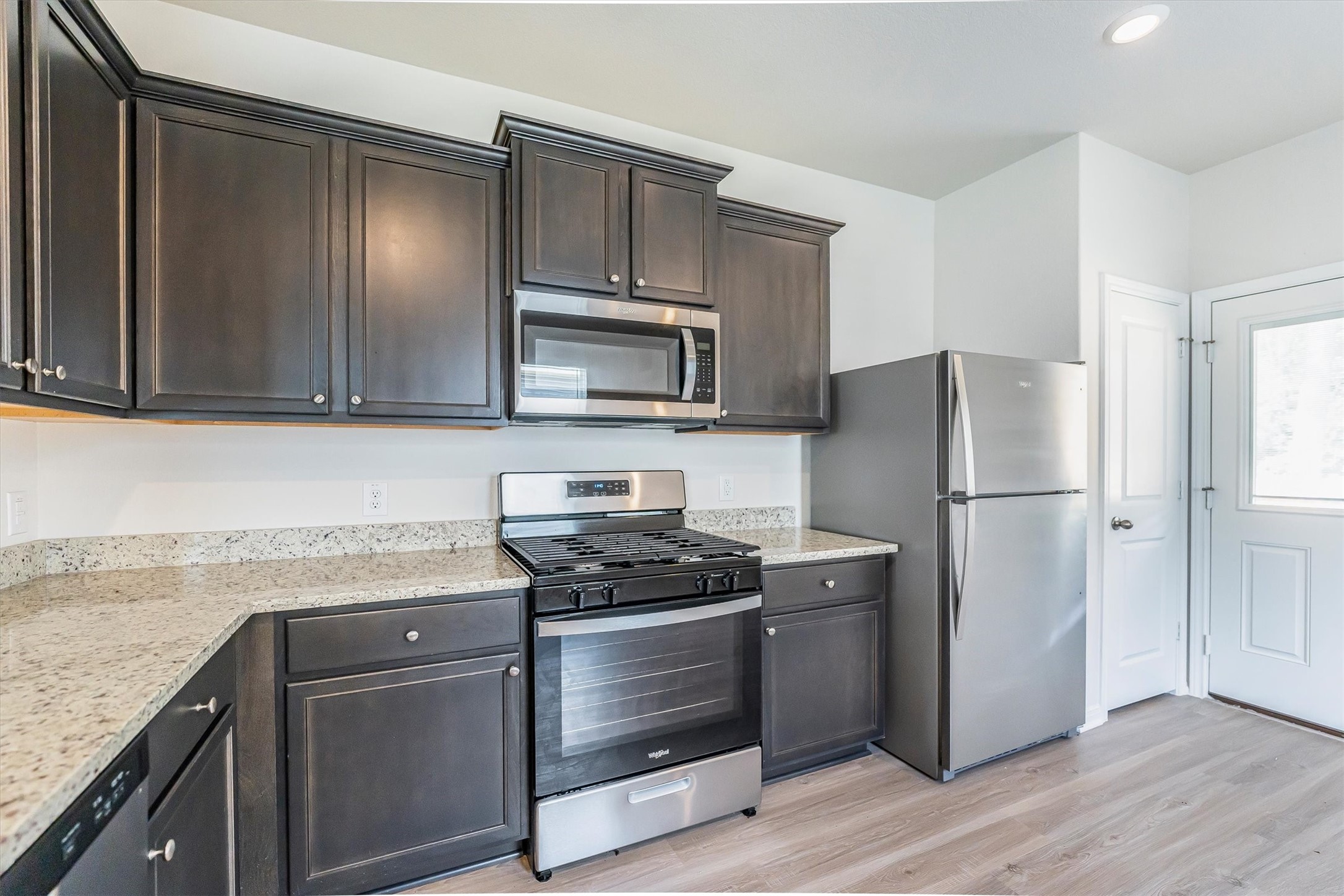 15419 Maple Ter Drive Conroe, TX 77303 - Photo 11 of 32 a kitchen with a refrigerator stove and microwave
