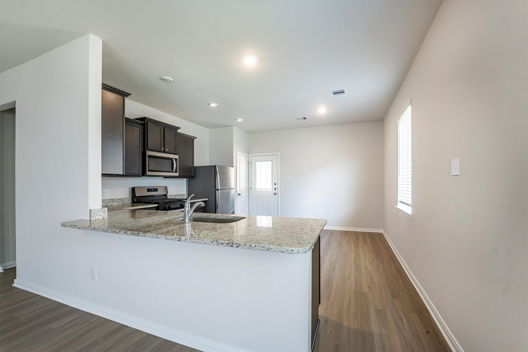 15419 Maple Ter Drive Conroe, TX 77303 - Photo 14 of 32 a kitchen with sink a microwave and cabinets