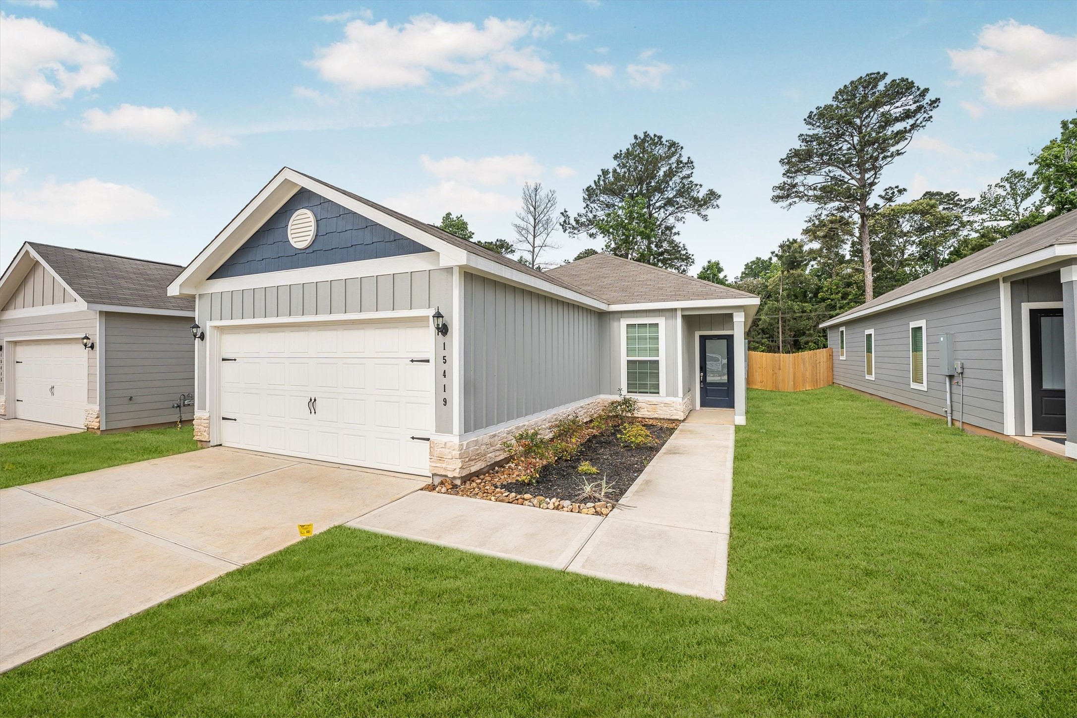 15419 Maple Ter Drive Conroe, TX 77303 - Photo 3 of 32 a front view of a house with a yard and garage