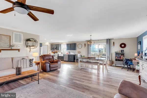 a living room with fireplace furniture and a wooden floor