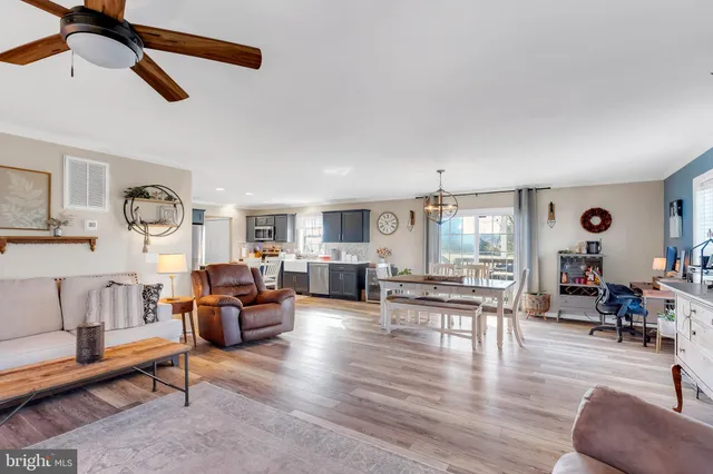 a living room with fireplace furniture and a wooden floor