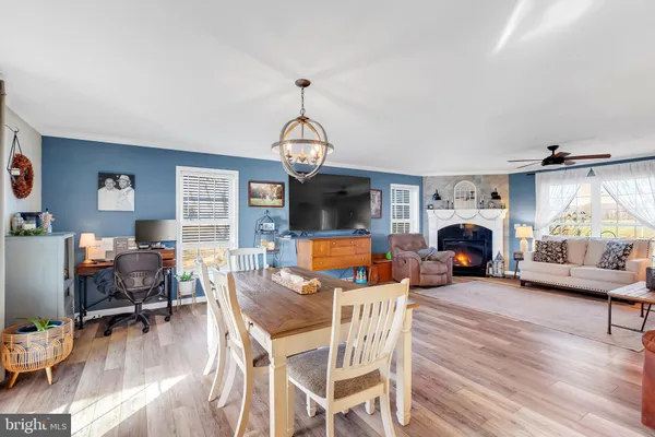 a living room with furniture a flat screen tv and a window