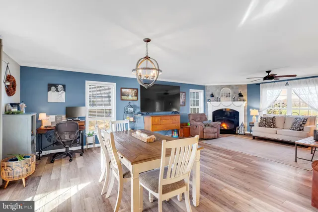 a living room with furniture a flat screen tv and a window
