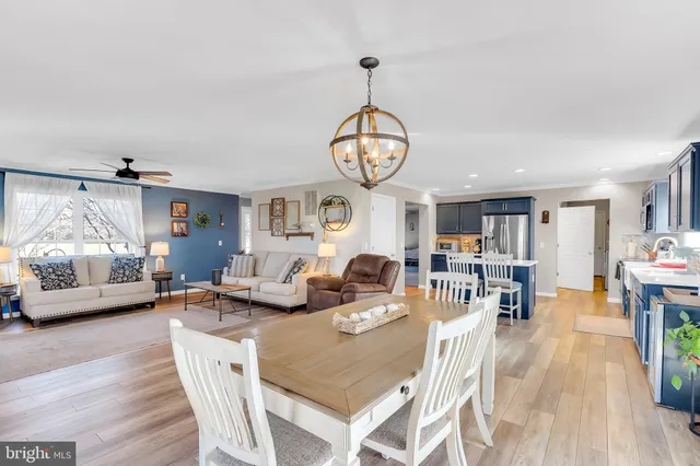 a living room with fireplace furniture and a wooden floor
