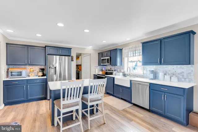 a kitchen with granite countertop a sink appliances and cabinets
