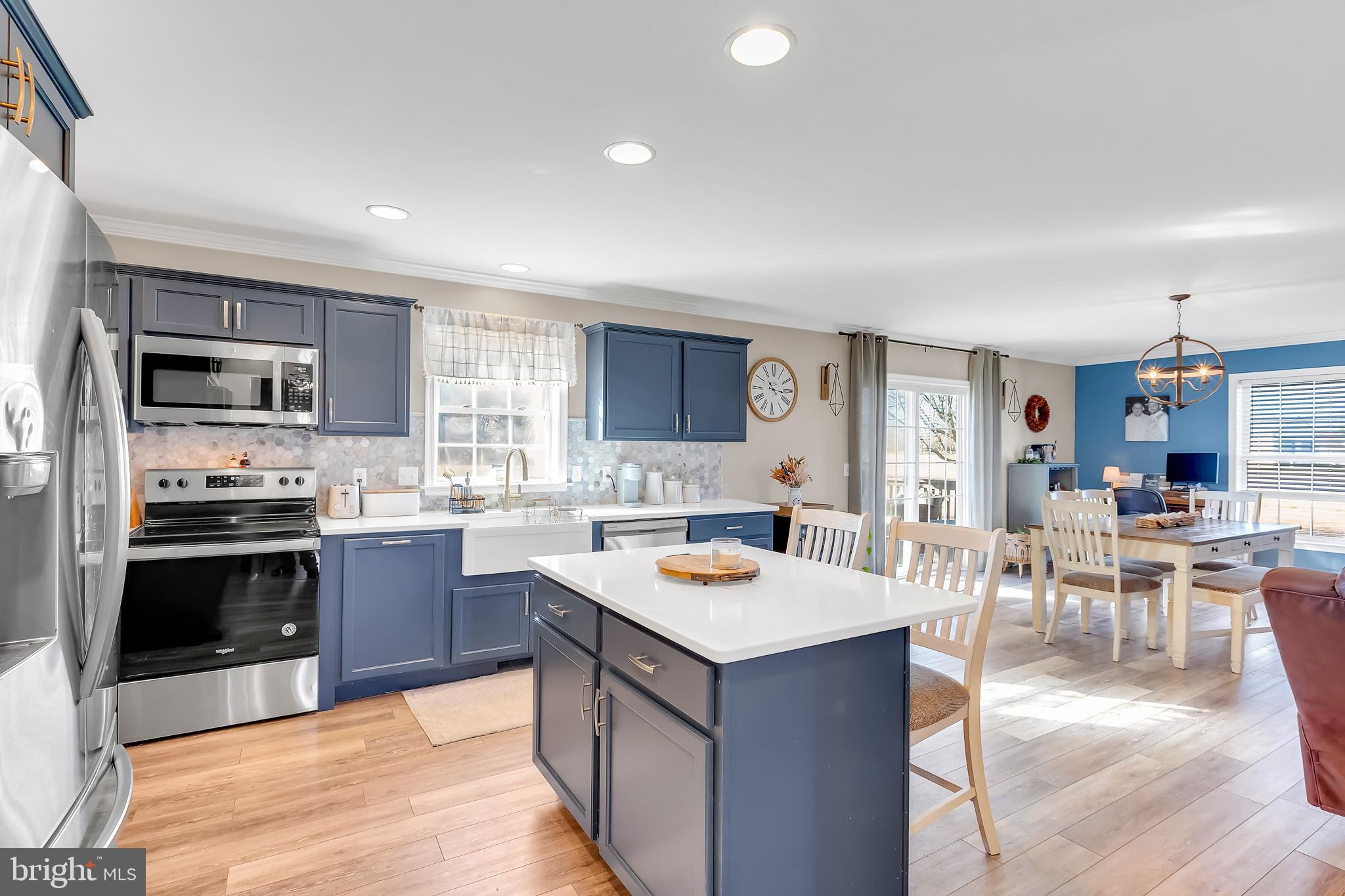 8960 Bacons Road Delmar, DE 19940 - Photo 20 of 51 a large kitchen with stainless steel appliances and a view of living room