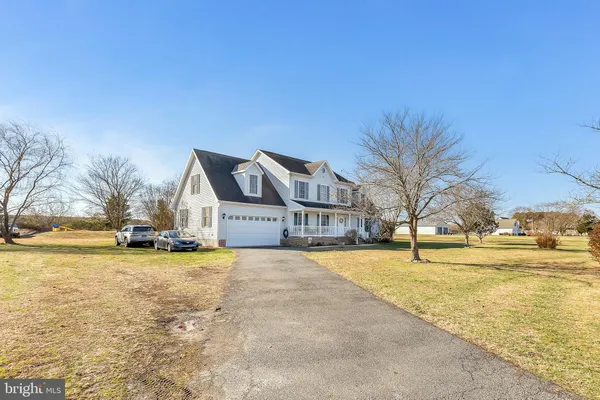 a view of a swimming pool and trees in front of house