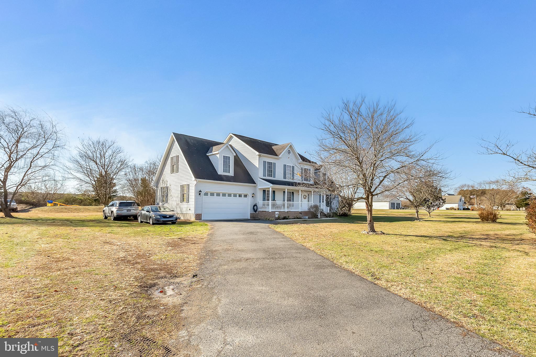 8960 Bacons Road Delmar, DE 19940 - Photo 2 of 51 a view of a swimming pool and trees in front of house