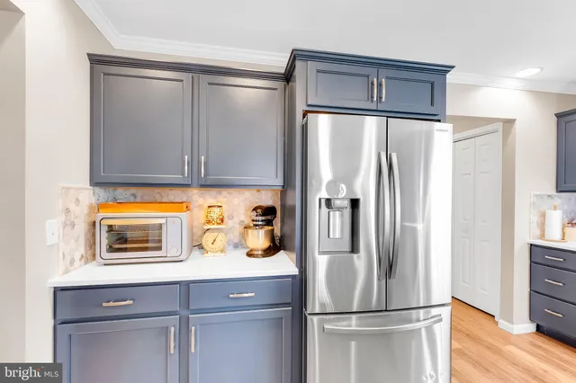a kitchen with stainless steel appliances granite countertop a refrigerator and a sink