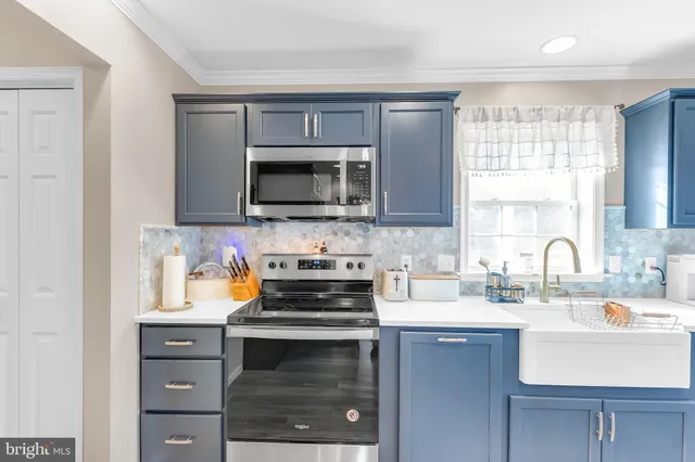 a kitchen with a microwave stove top oven and sink