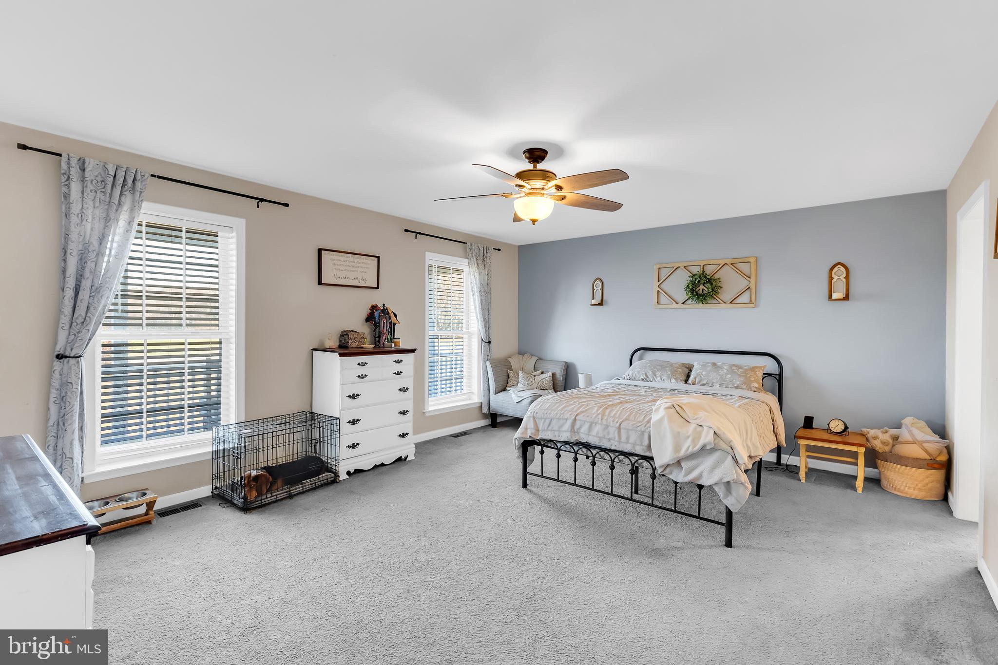 8960 Bacons Road Delmar, DE 19940 - Photo 26 of 51 a spacious bedroom with a bed and a chandelier