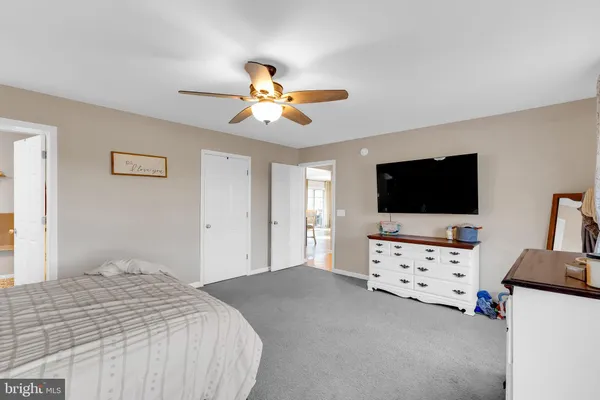 a bedroom with furniture and flat screen tv