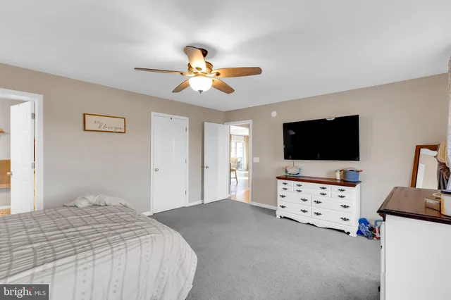 a bedroom with furniture and flat screen tv