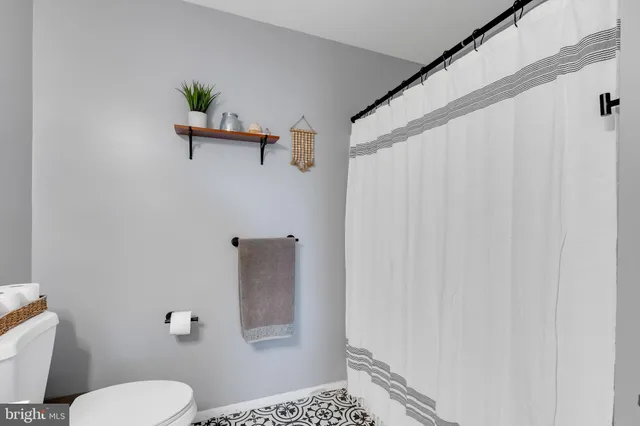 a bathroom with a toilet and a shower