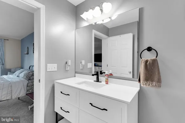 a bathroom with a sink vanity and a mirror