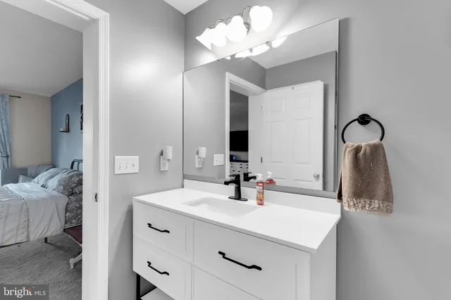 a bathroom with a sink vanity and a mirror