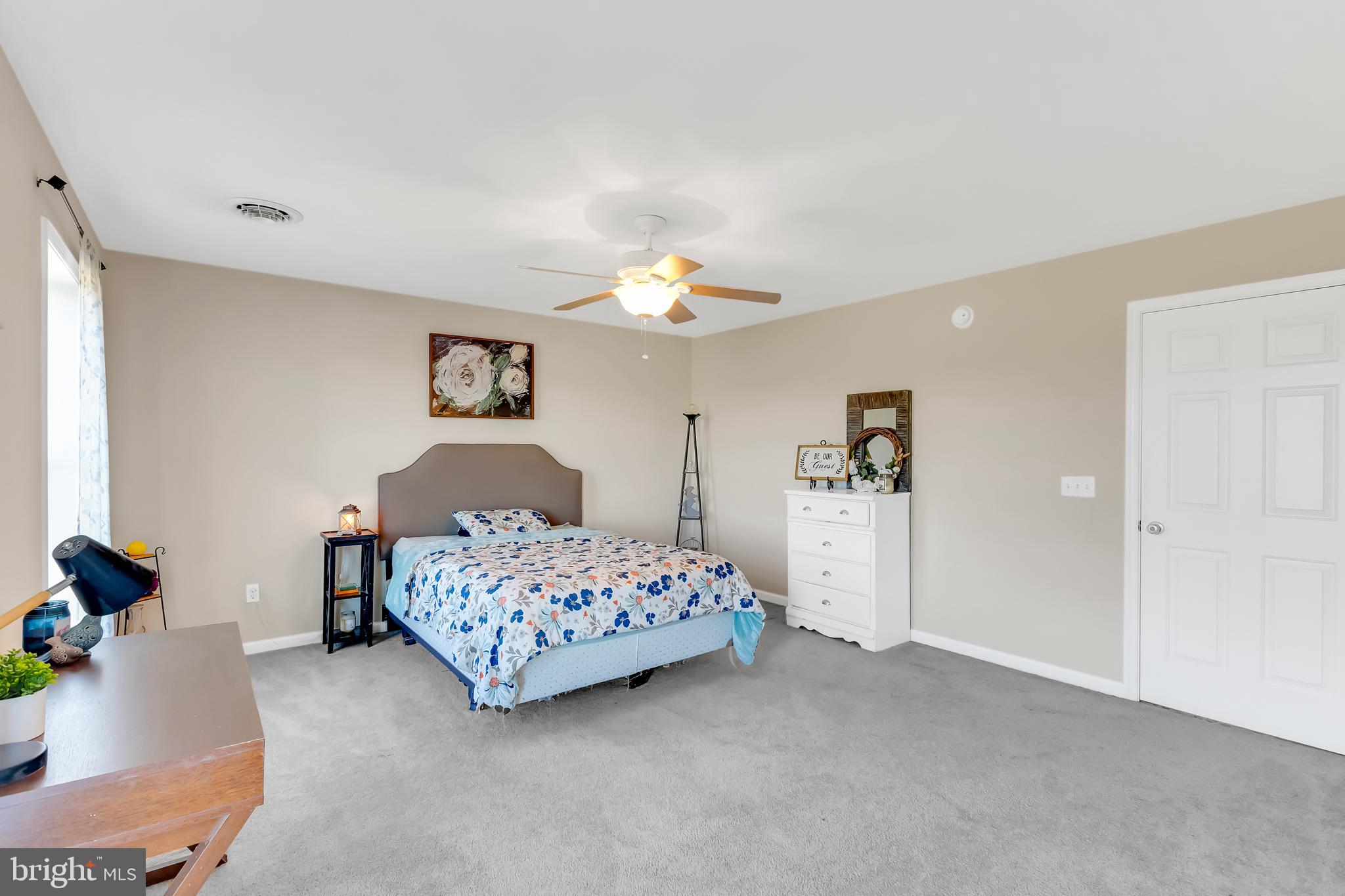 8960 Bacons Road Delmar, DE 19940 - Photo 36 of 51 a bedroom with a bed and a chandelier