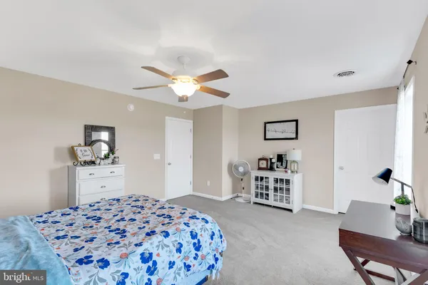 a bedroom with a bed and dresser