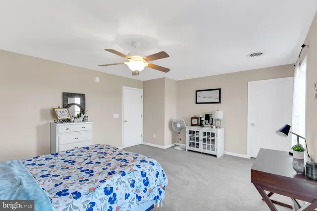 a bedroom with a bed and dresser