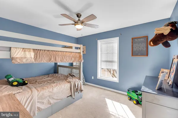 a bedroom with a bed a window and a chandelier