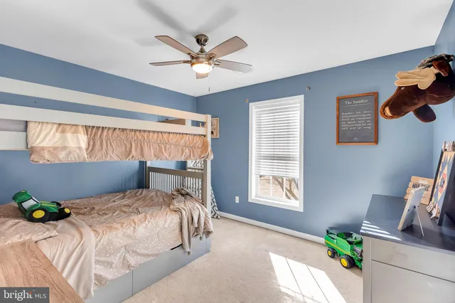 a bedroom with a bed a window and a chandelier