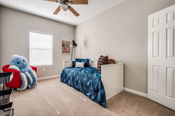 a bedroom with two bed and a window