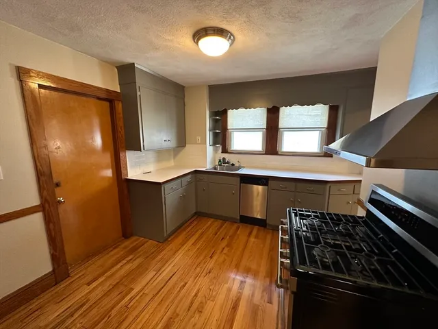 a kitchen with granite countertop a stove and a refrigerator