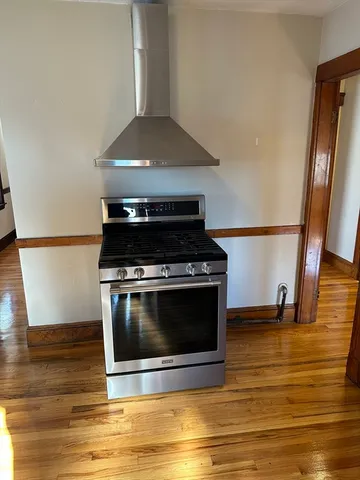 a stove top oven sitting inside of a kitchen