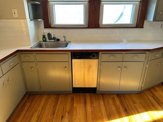 a bathroom with a sink a mirror and cabinets