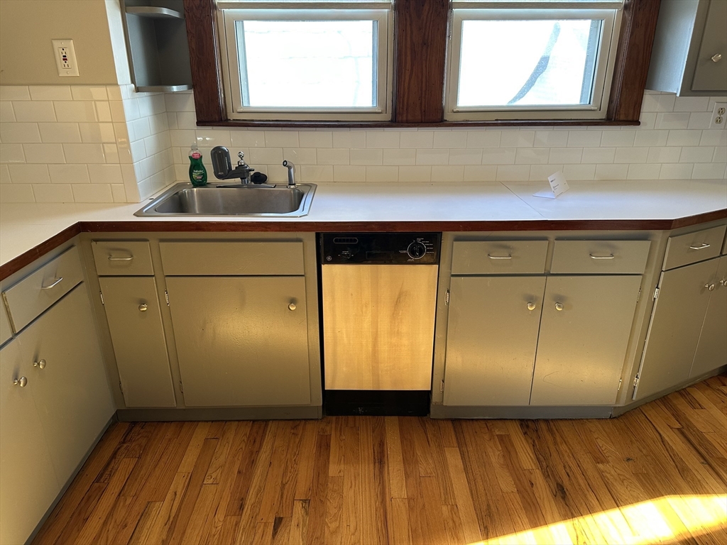 77 Walk Hill Street, Unit 1 Boston, MA 02130 - Photo 15 of 29 a bathroom with a sink a mirror and cabinets
