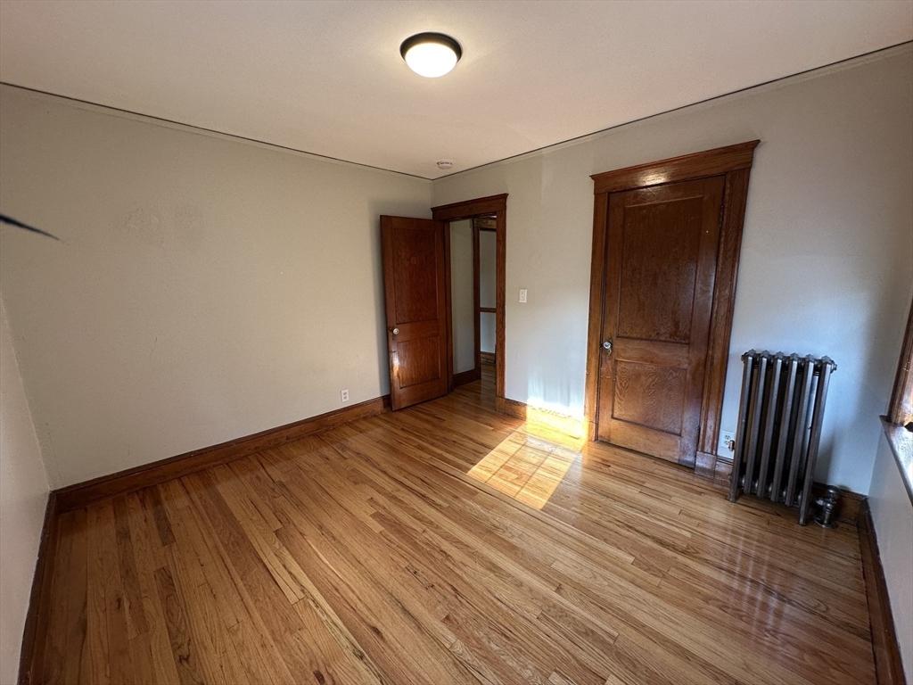 77 Walk Hill Street, Unit 1 Boston, MA 02130 - Photo 18 of 29 a view of empty room with wooden floor