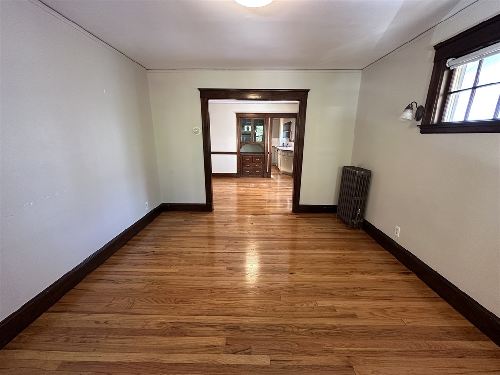 77 Walk Hill Street, Unit 1 Boston, MA 02130 - Photo 2 of 29 a view of empty room with wooden floor and fan