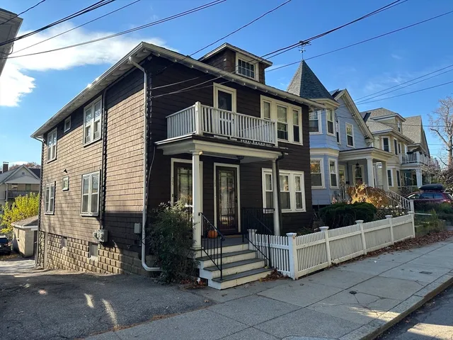 a front view of a house with a garden