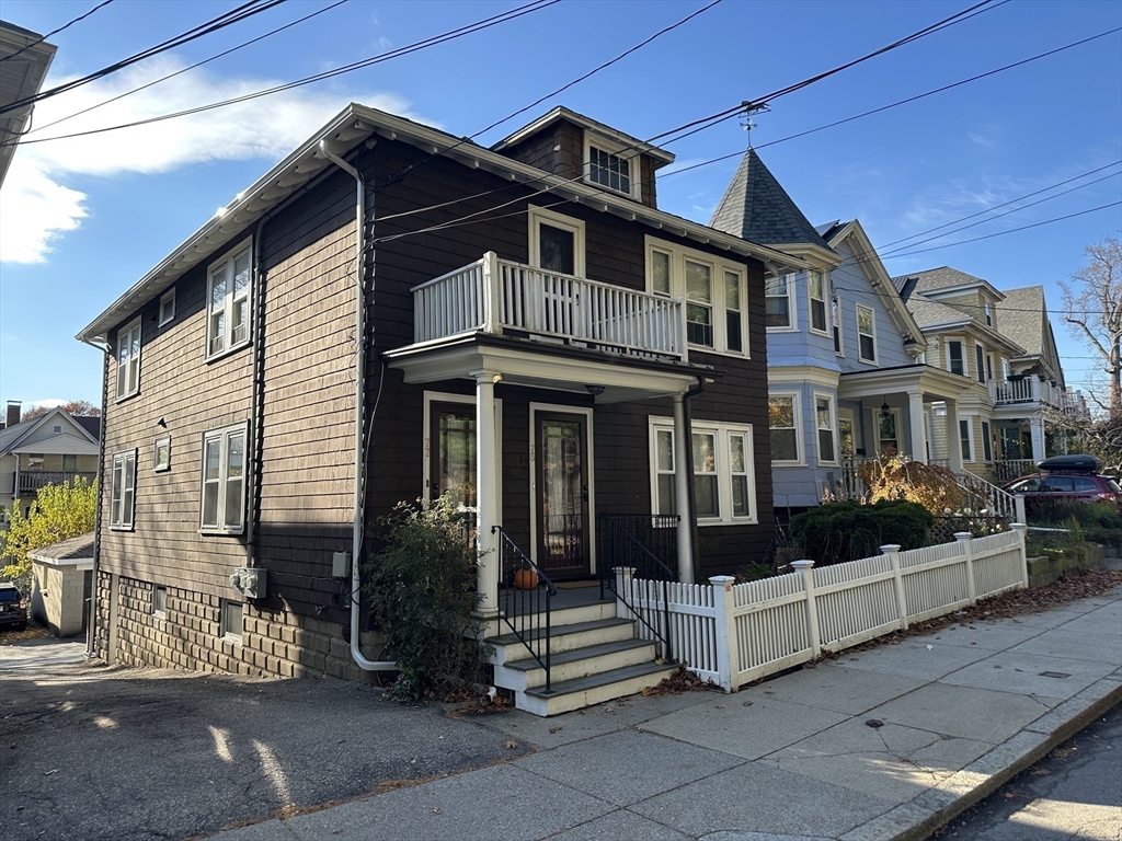 77 Walk Hill Street, Unit 1 Boston, MA 02130 - Photo 25 of 29 a front view of a house with a garden