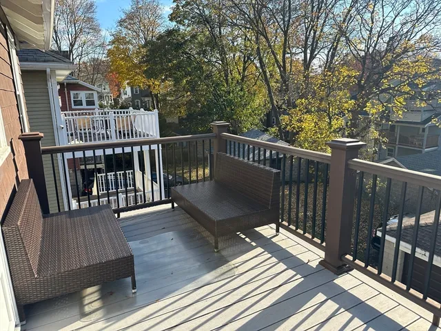 a view of balcony with wooden floor and fence